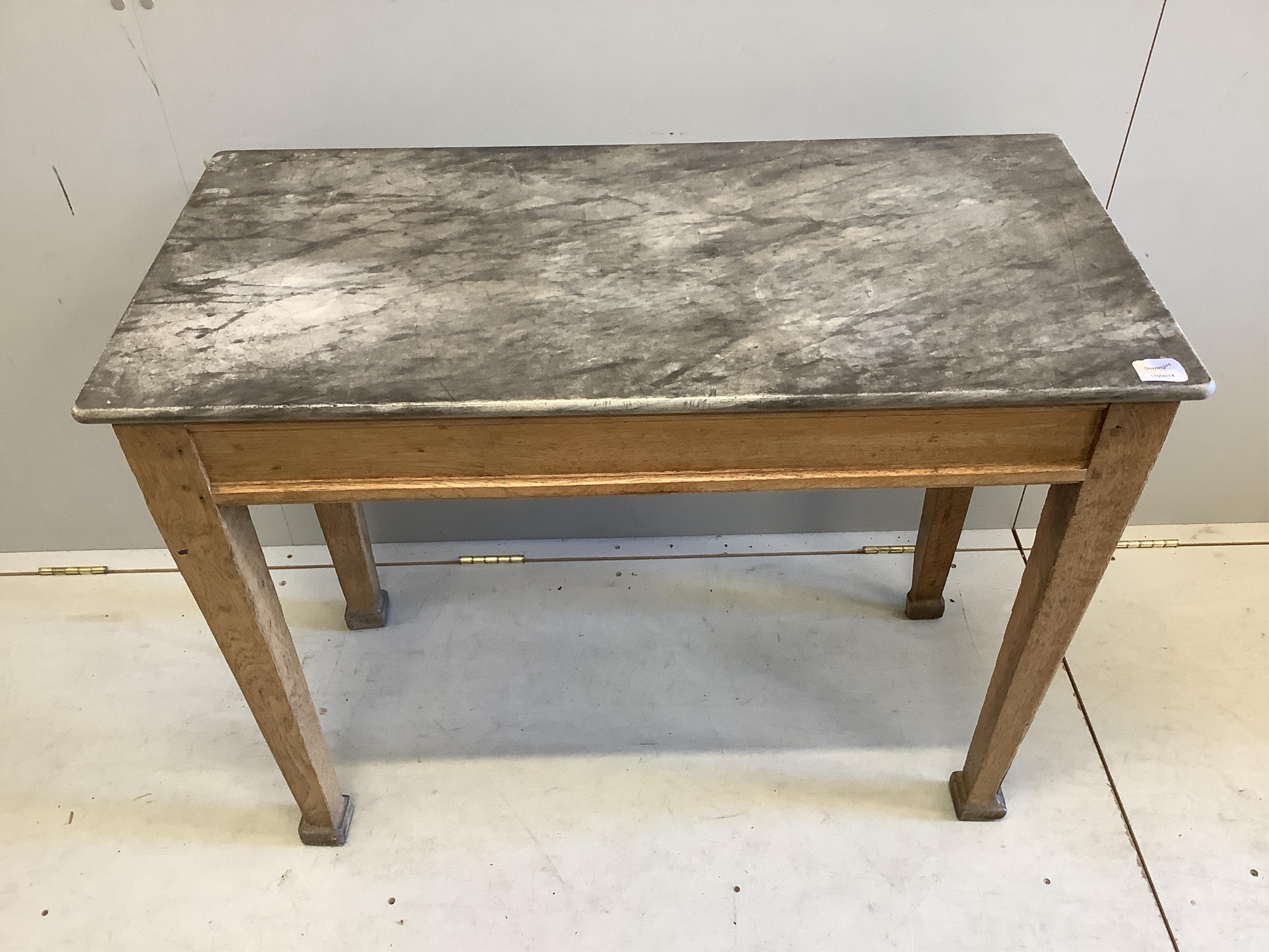 An early 20th century rectangular marble topped oak table, width 100cm, depth 49cm, height 75cm. Condition - poor to fair
